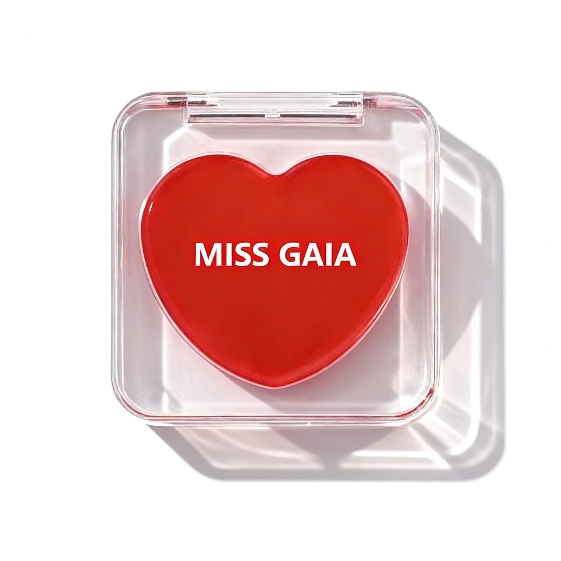 Bright red cheek balm in a clear heart compact. Private label cosmetic manufacturing by MCcosme.