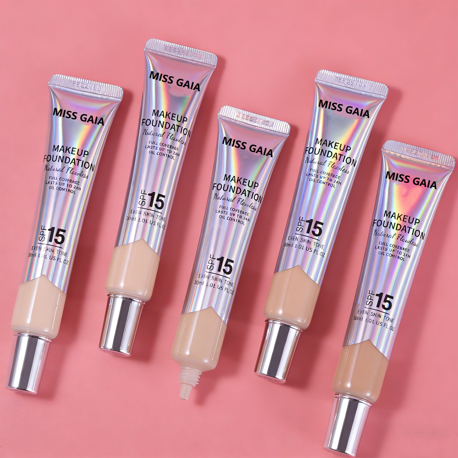 Assortment of holographic foundation tubes, demonstrating mass production capacity for global cosmetic vendors.