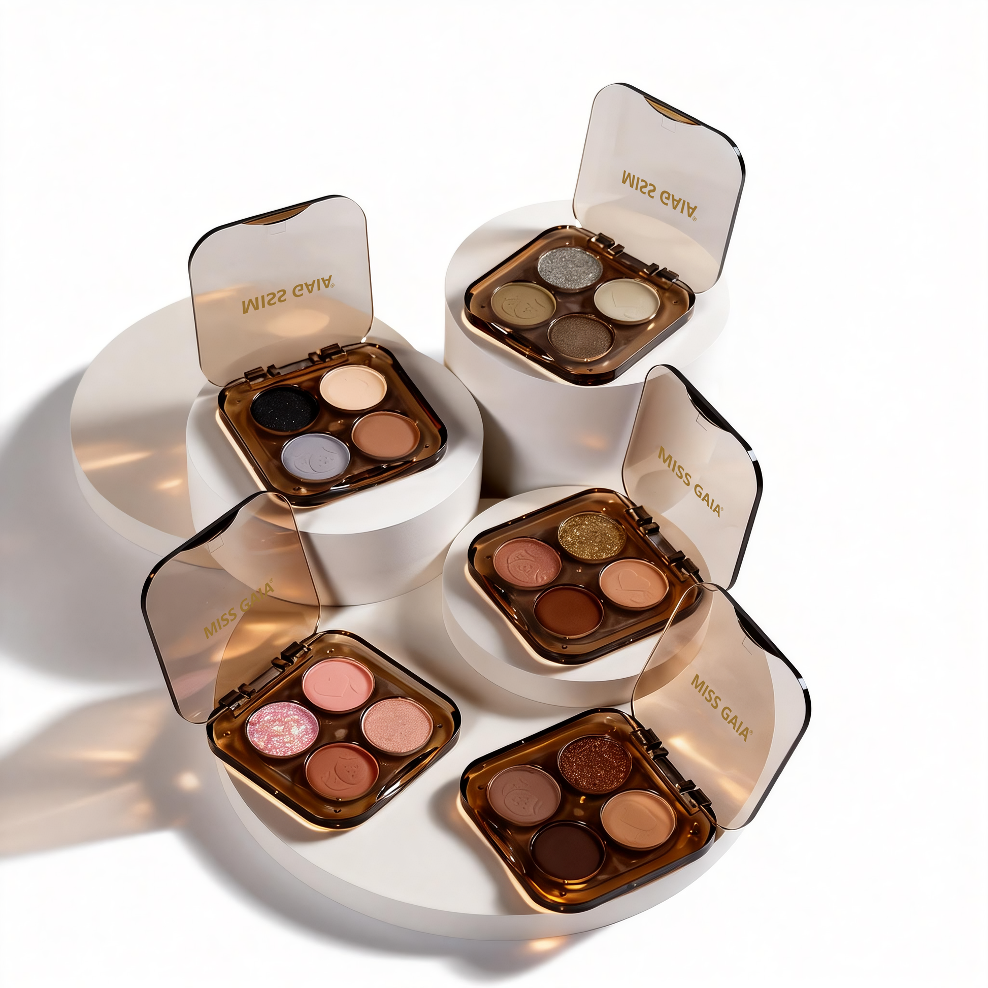 Display of custom 4-color eyeshadow palettes showing compact clear brown packaging. MCcosme is a leading OEM cosmetic factory for global brands