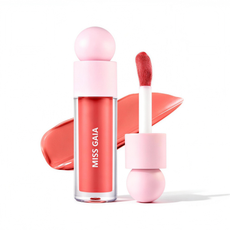Close-up of coral liquid blush with large doe-foot applicator, popular packaging component for custom makeup lines.