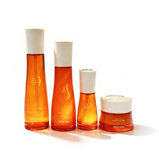 Four-piece multi-vitamin brightening skincare set with orange glass bottles for private label manufacturing